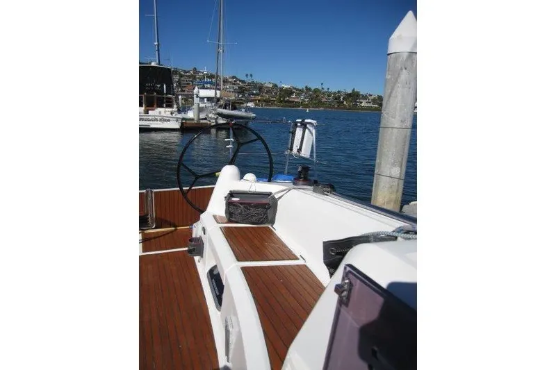 Slide: The Image of Jeanneau Sun Odyssey 349 sailboat cockpit with wooden deck, docked in a marina, 2021 model. - 33