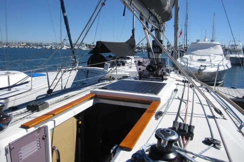 Slide: The Image of 2021 Jeanneau Sun Odyssey 349 sailboat docked in a marina, sunny day. - 34