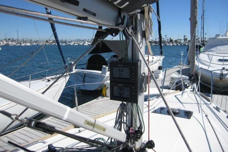 Slide: The Image of 2021 Jeanneau Sun Odyssey 349 sailboat docked at marina with navigation instruments visible. - 35