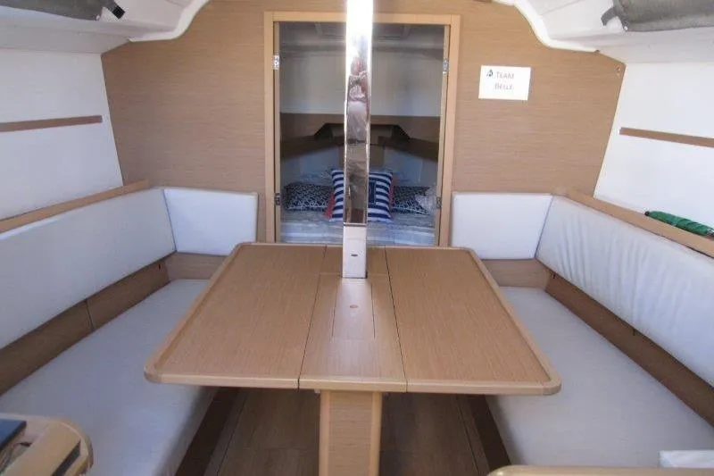 Slide: The Image of Interior of 2021 Jeanneau Sun Odyssey 349 sailboat with cozy seating and table. - 4