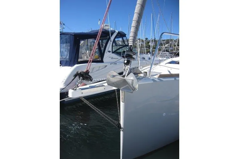 Slide: The Image of 2021 Jeanneau Sun Odyssey 349 sailboat anchored in marina, featuring sleek design and modern rigging. - 43