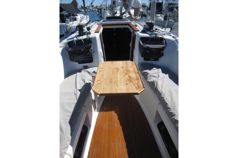Slide: The Image of 2021 Jeanneau Sun Odyssey 349 cockpit with wooden table and seating. - 45
