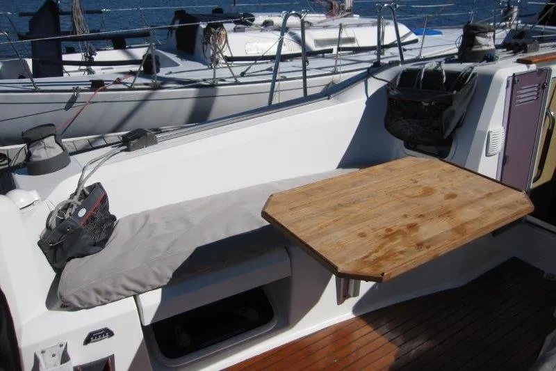 Slide: The Image of Cockpit of 2021 Jeanneau Sun Odyssey 349 with wooden table and cushioned seating. - 47