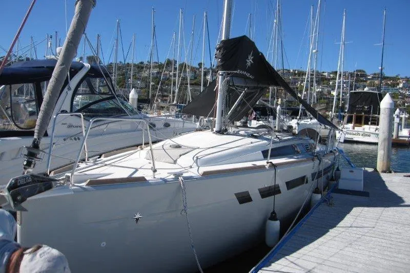 Slide: The Image of 2021 Jeanneau Sun Odyssey 349 sailboat docked at a marina, surrounded by other boats. - 51
