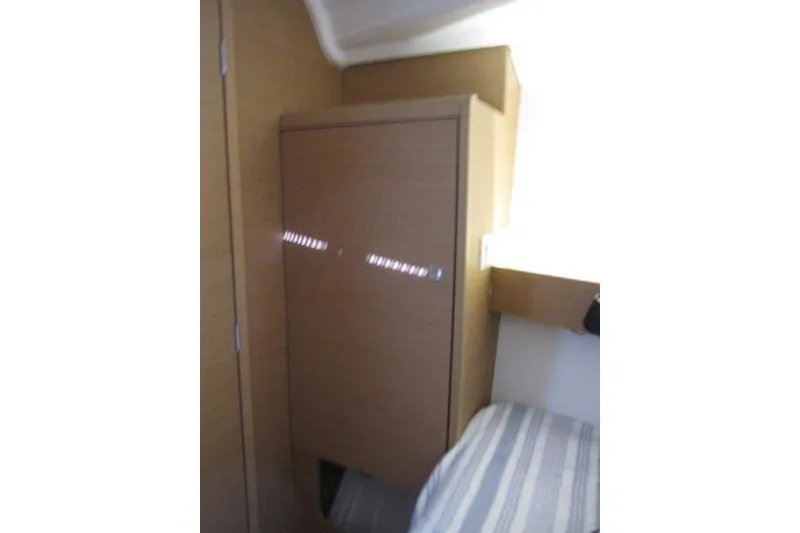 Slide: The Image of Interior cabin of 2021 Jeanneau Sun Odyssey 349 sailboat, featuring wooden cabinetry. - 6