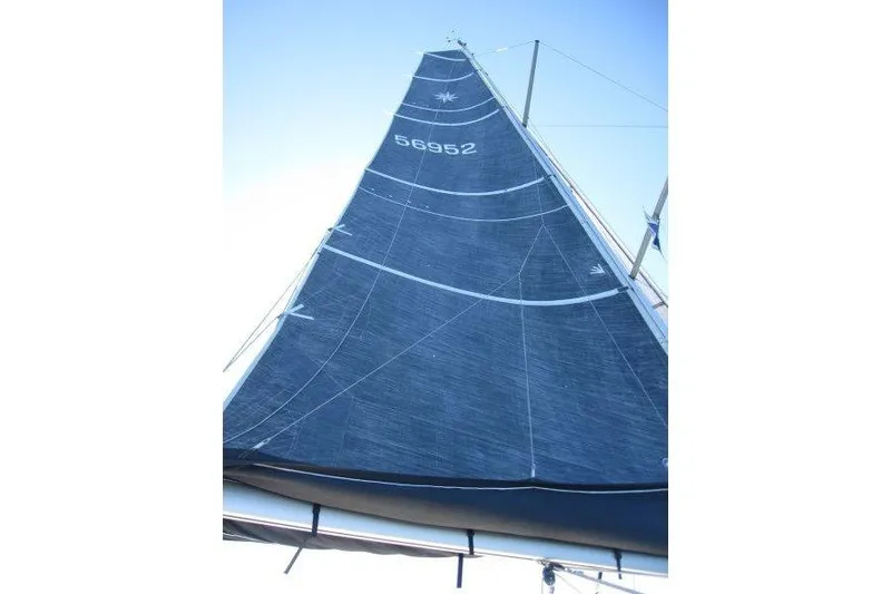 Slide: The Image of Sail of Jeanneau Sun Odyssey 349, 2021 model, against clear blue sky. - 61
