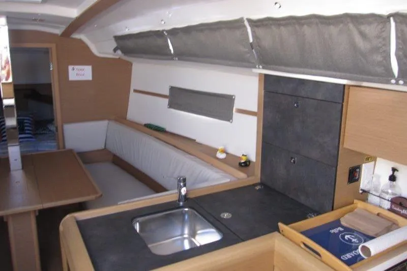 Slide: The Image of Interior of 2021 Jeanneau Sun Odyssey 349 yacht with modern kitchen and seating area. - 7