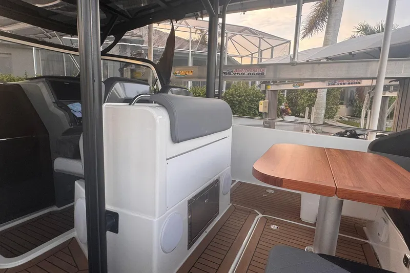 Slide: The Image of Interior of 2021 Nimbus T9 boat with seating and wooden table. - 11