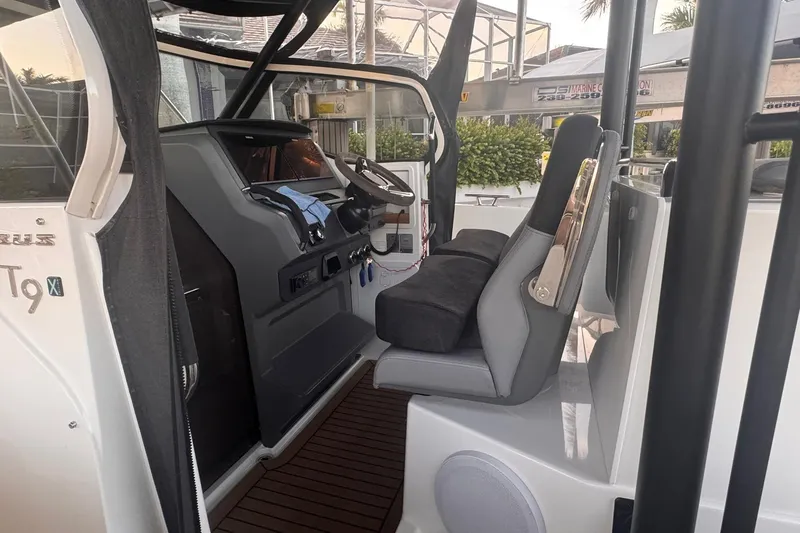 Slide: The Image of Interior of a 2021 Nimbus T9 boat, featuring a modern helm and seating area. - 7