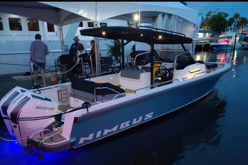 The Image of 2021 Nimbus T9 boat docked at marina, illuminated at dusk with Mercury engines. - 0