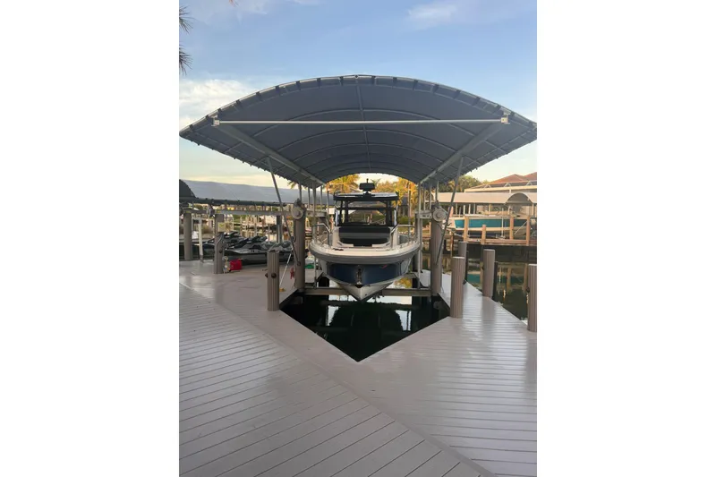 Slide: The Image of Nimbus T9 2021 boat docked under canopy on a sunny day. - 17