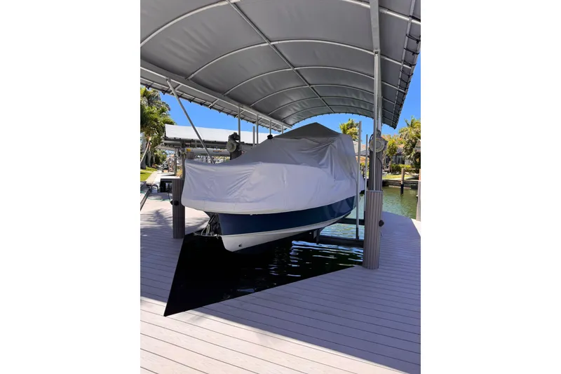 Slide: The Image of Covered 2021 Nimbus T9 boat on a dock under a canopy. - 18