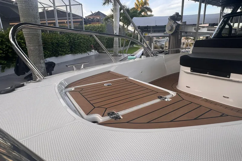 Slide: The Image of 2021 Nimbus T9 boat deck with teak flooring and stainless steel railings. - 9