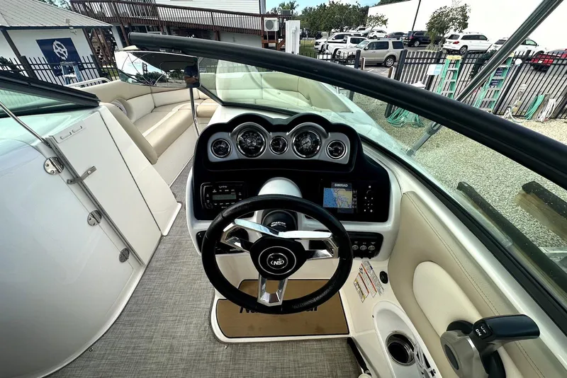 Slide: The Image of 2022 NauticStar 243 DC boat cockpit with steering wheel and navigation system. - 10