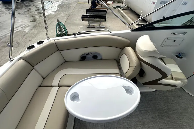 Slide: The Image of 2022 NauticStar 243 DC boat interior with seating and table. - 12