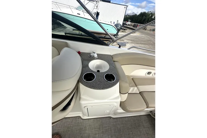 Slide: The Image of 2022 NauticStar 243 DC boat interior with sink and cup holders. - 14