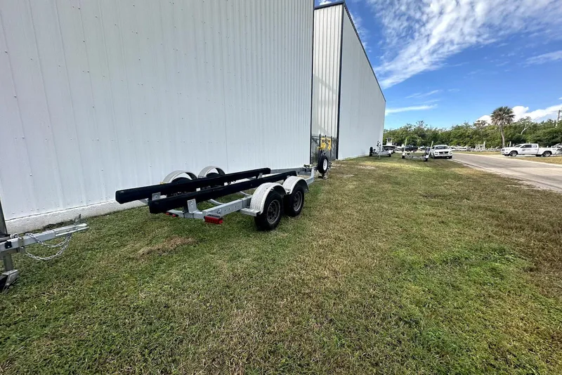 Slide: The Image of Boat trailer near large building, grassy area, clear sky; NauticStar 243 DC 2022. - 21