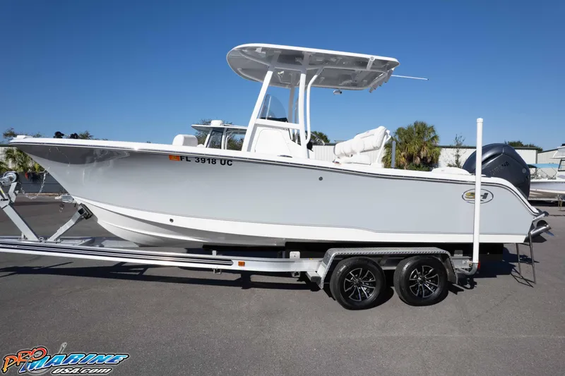 Slide: The Image of 2025 Sea Hunt Ultra 229 boat on trailer, side view, sunny day. - 11