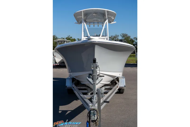 Slide: The Image of 2025 Sea Hunt Ultra 229 boat on trailer, front view, clear sky background. - 14