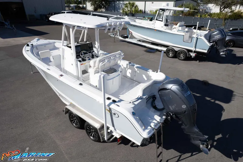 Slide: The Image of 2025 Sea Hunt Ultra 229 boat on trailer, featuring Yamaha outboard motor, parked outdoors. - 19