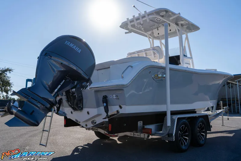 Slide: The Image of 2025 Sea Hunt Ultra 229 boat with Yamaha engine on trailer, sunny day. - 24