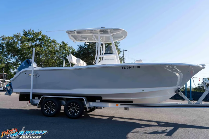 Slide: The Image of 2025 Sea Hunt Ultra 229 boat on trailer, side view, outdoors. - 26