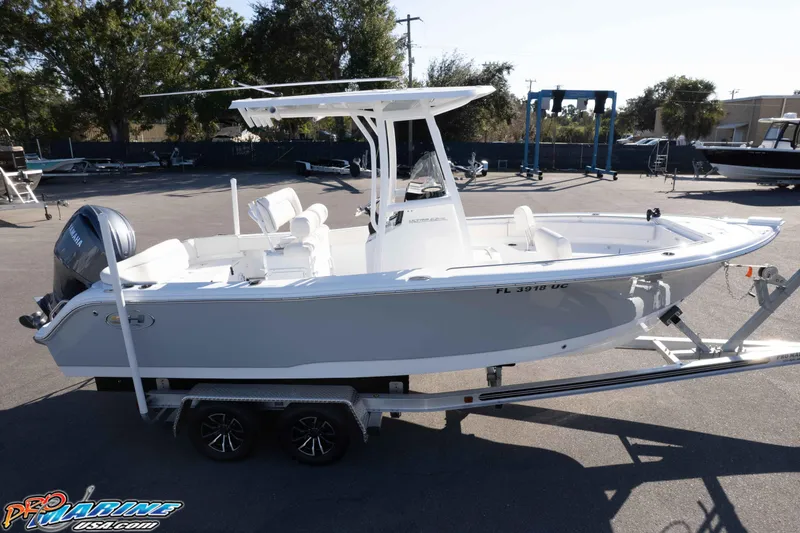 Slide: The Image of 2025 Sea Hunt Ultra 229 boat on trailer, parked outdoors, side view. - 27