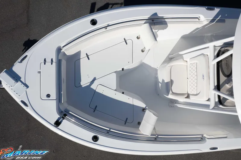 Slide: The Image of 2025 Sea Hunt Ultra 229 boat interior, top view, showcasing seating and storage areas. - 31