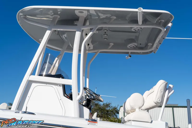 Slide: The Image of 2025 Sea Hunt Ultra 229 boat with T-top and seating, under clear blue sky. - 33