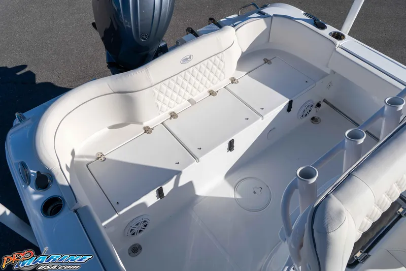 Slide: The Image of 2025 Sea Hunt Ultra 229 boat interior with white seating and storage compartments. - 34