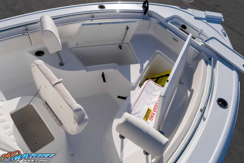 Slide: The Image of 2025 Sea Hunt Ultra 229 boat interior with open storage compartments and seating. - 39