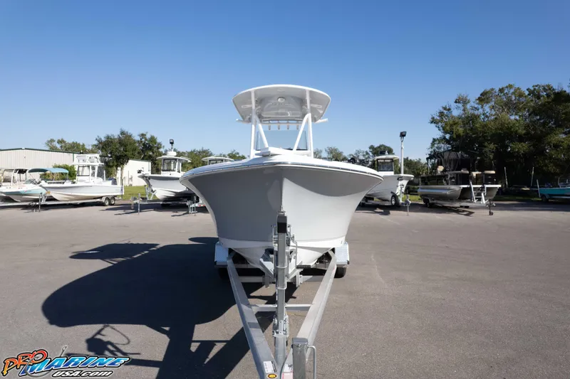 Slide: The Image of 2025 Sea Hunt Ultra 229 boat on trailer in outdoor showroom. - 4