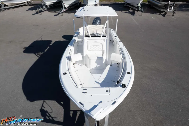 Slide: The Image of 2025 Sea Hunt Ultra 229 boat, white exterior, parked on a trailer in a lot. - 6