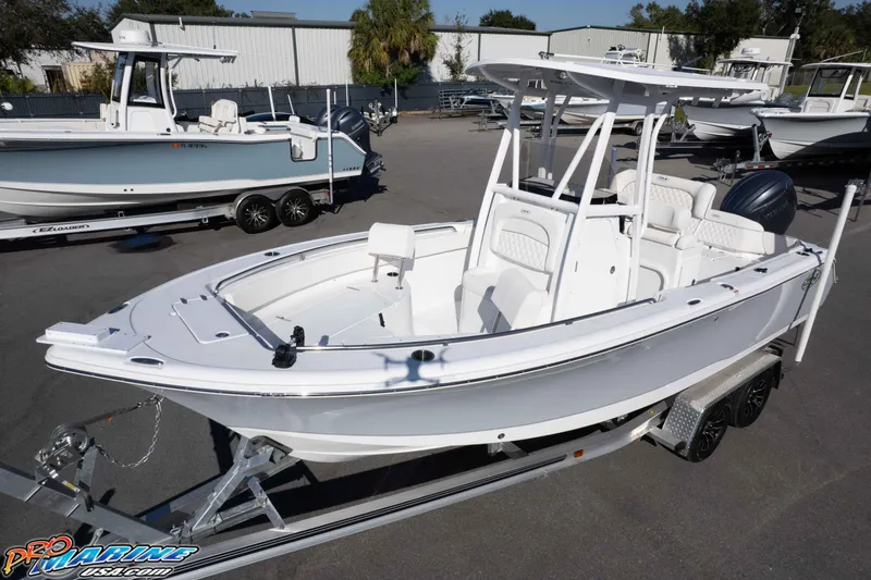 Slide: The Image of 2025 Sea Hunt Ultra 229 boat on trailer, displayed outdoors at dealership. - 8