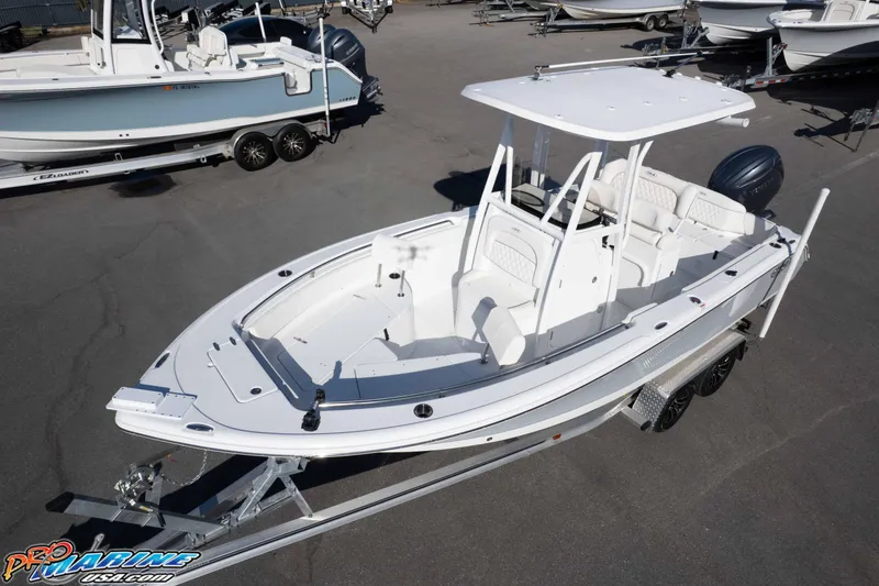 Slide: The Image of 2025 Sea Hunt Ultra 229 boat on trailer, displayed in a marina setting. - 9