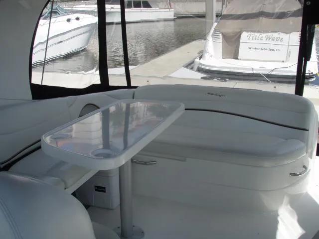 Slide: The Image of 2003 Wellcraft 3300 Martinique boat interior with seating and table, docked at marina. - 11