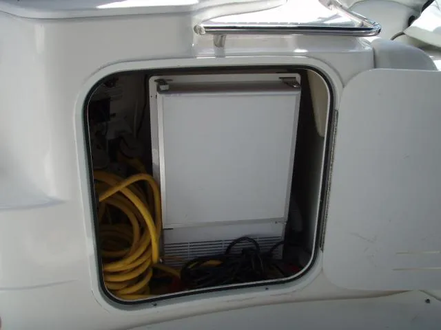 Slide: The Image of Storage compartment of a 2003 Wellcraft 3300 Martinique boat with cables and equipment. - 12
