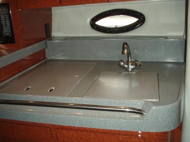 Slide: The Image of 2003 Wellcraft 3300 Martinique kitchen area with sink and countertop. - 14