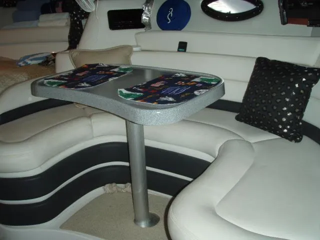 Slide: The Image of 2003 Wellcraft 3300 Martinique interior with curved seating and table. - 18