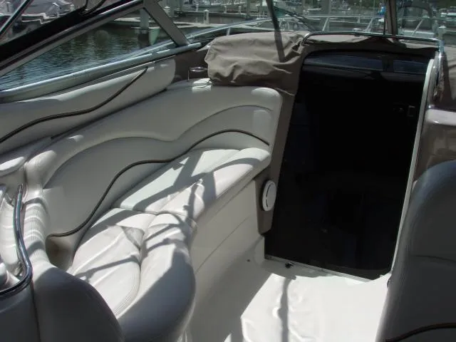 Slide: The Image of 2003 Wellcraft 3300 Martinique boat interior with white seating and open cabin entrance. - 5