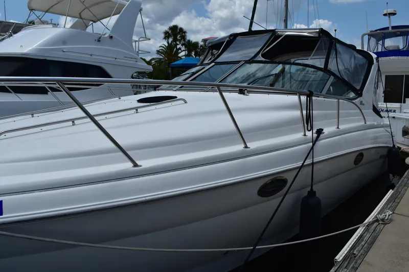Slide: The Image of 2003 Wellcraft 3300 Martinique boat docked, featuring sleek design and spacious deck. - 6