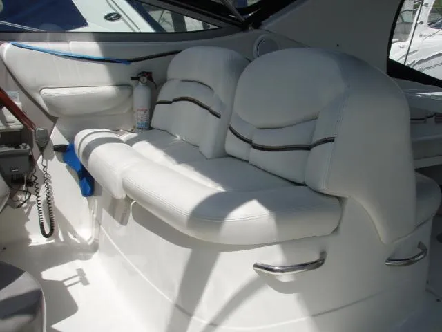Slide: The Image of 2003 Wellcraft 3300 Martinique boat interior with white seating and safety equipment. - 9