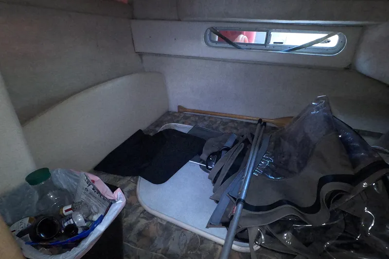 Slide: The Image of Interior cabin of 2000 Bayliner 2855 Ciera with storage items and window view. - 10