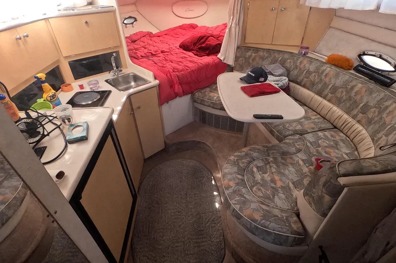 Slide: The Image of Interior of a 2000 Bayliner 2855 Ciera boat with kitchen and seating area. - 11