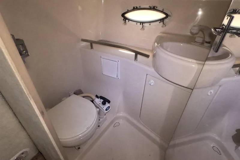 Slide: The Image of Bathroom interior of 2000 Bayliner 2855 Ciera boat with toilet and sink. - 13