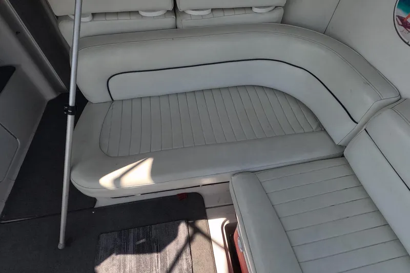 Slide: The Image of Interior seating of a 2000 Bayliner 2855 Ciera boat, featuring white upholstery. - 15