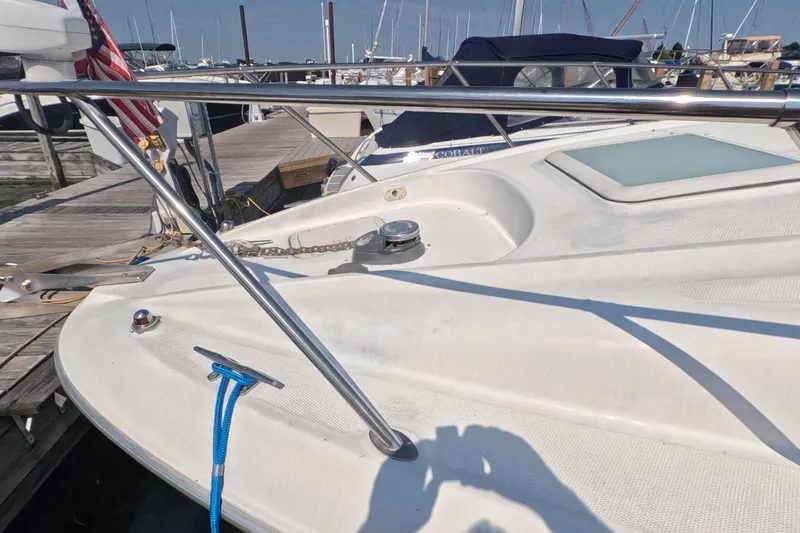 Slide: The Image of 2000 Bayliner 2855 Ciera boat docked, featuring deck details and mooring equipment. - 2