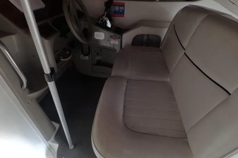 Slide: The Image of Interior of a 2000 Bayliner 2855 Ciera boat showing steering wheel and seating area. - 5