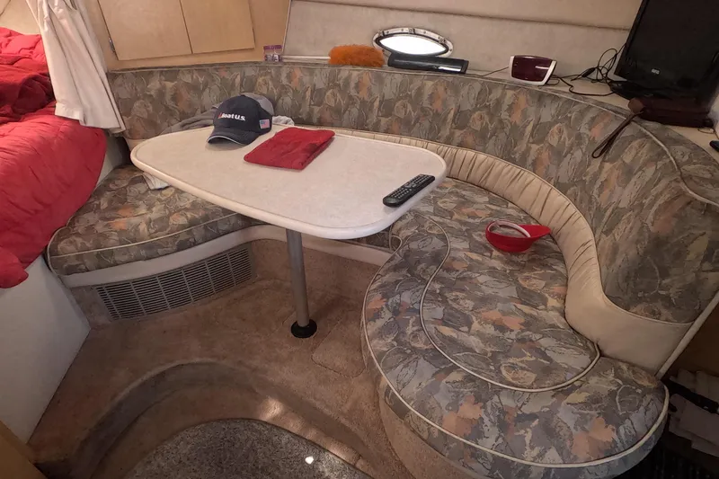 Slide: The Image of 2000 Bayliner 2855 Ciera cabin interior with curved seating and table. - 7