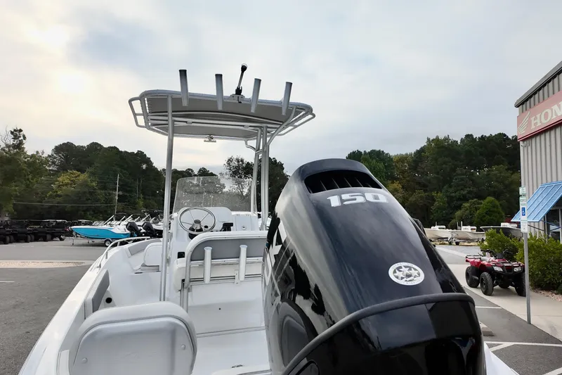 Slide: The Image of 2026 ALK2 22CRX boat with 150 horsepower engine, parked outdoors near dealership. - 14